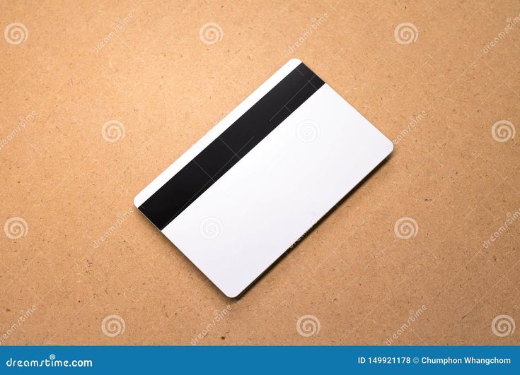 a white and black notepad on a brown background