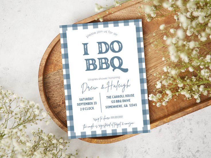 a blue and white gingham baby's breath card on a wooden platter