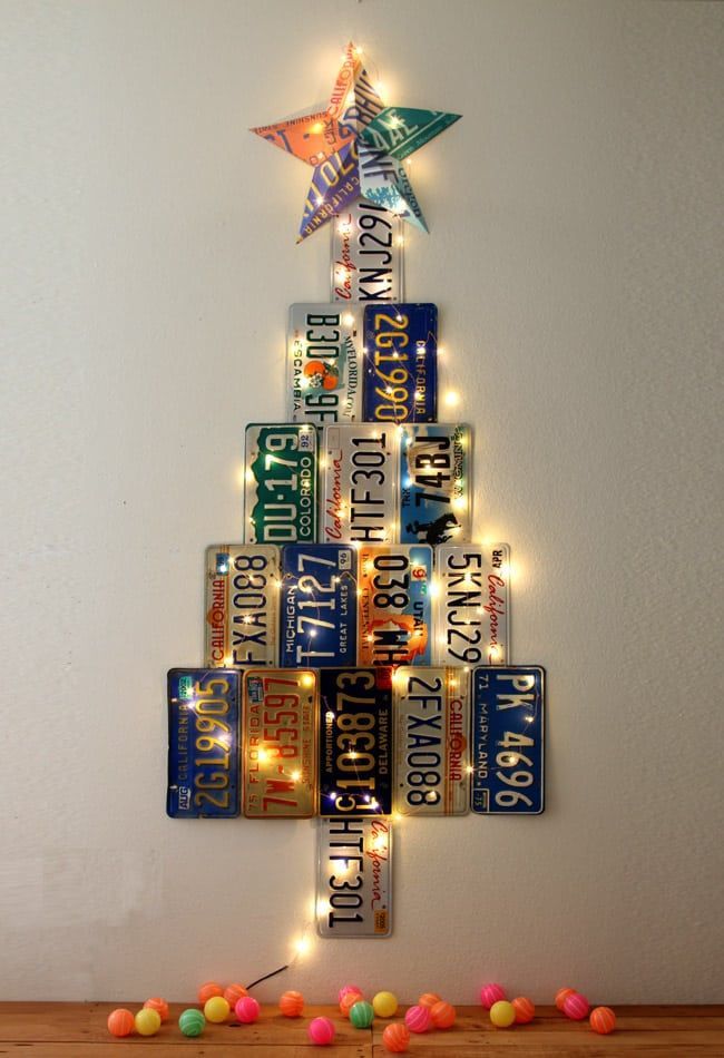 a christmas tree made out of license plates with lights on it and the words, shut the front door these days