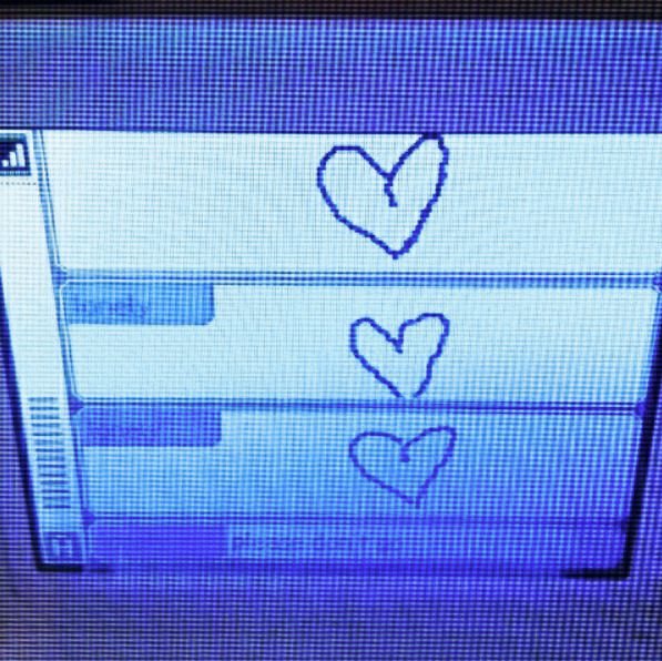 two hearts are drawn on the screen of a television