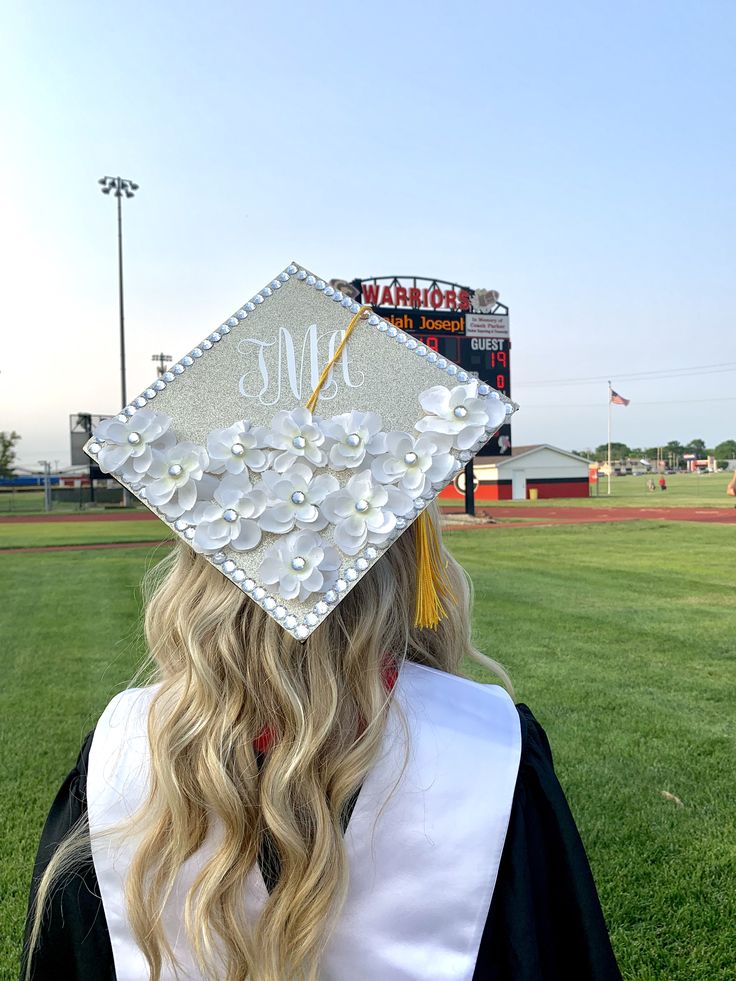 a woman wearing a graduation cap with flowers on it