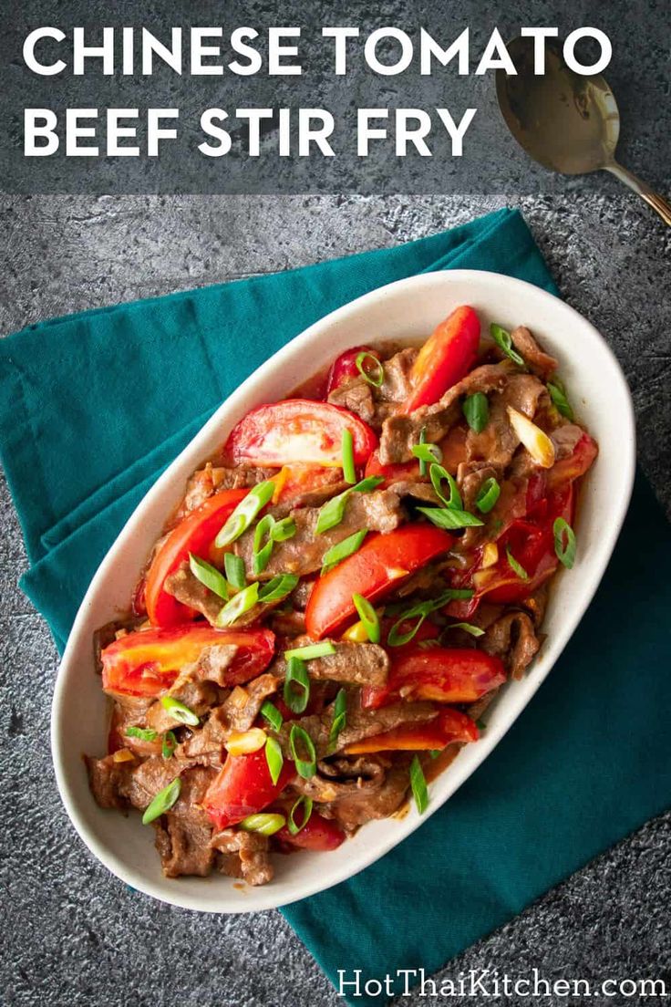 chinese tomato beef stir fry in a white bowl