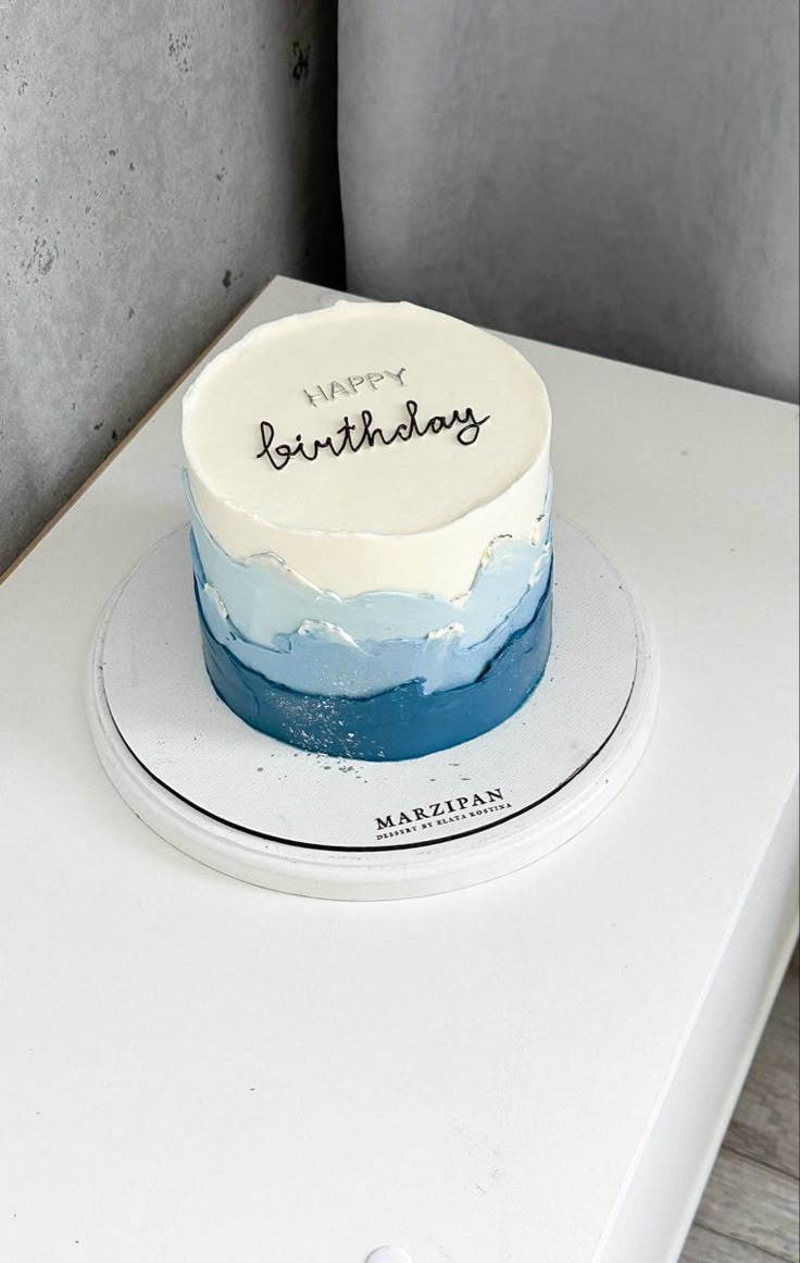 a birthday cake sitting on top of a white table