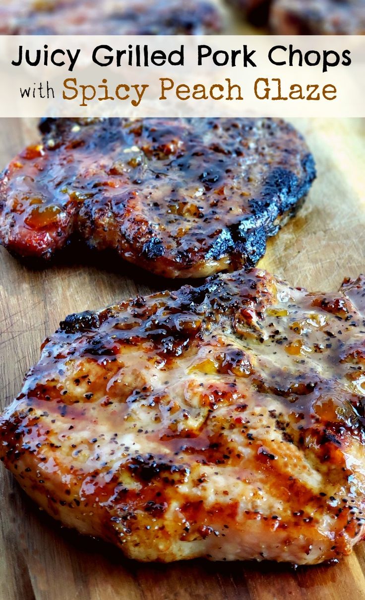 juicy grilled pork chops with spicy peach glaze on a wooden cutting board