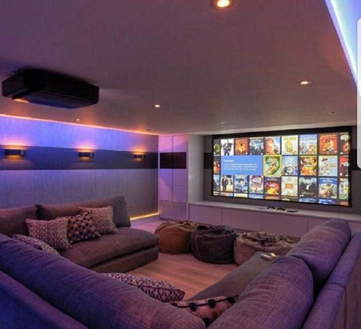 a living room filled with furniture and a flat screen tv mounted to the wall above it