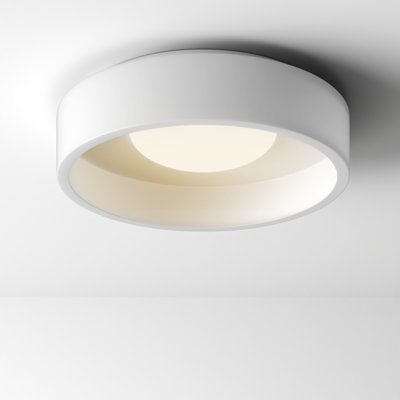 a white circular light fixture mounted on the ceiling