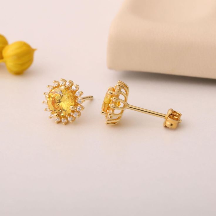 Brighten up your accessory collection with our exquisite Round Yellow Topaz 14K Solid Gold Stud Earrings, elegantly surrounded by real diamonds. These stunning earrings are designed to capture the light with their vibrant yellow hue, embodying warmth and joy. Crafted from high-quality 14K solid gold, they provide a luxurious touch while ensuring durability for everyday wear. The rich golden tone beautifully complements the sparkling diamonds, creating a piece that will remain timeless in your jewelry box. Each stud earring features a round yellow topaz as the centerpiece, showcasing the beautiful clarity and brilliance that this birthstone embodies. They are designed for comfort, making them easy to wear all day long while their secure post back closures provide both style and function to Gold Topaz Gemstone Earrings, Elegant Yellow Earrings With Halo Design, Gold Topaz Earrings For Wedding, Yellow Halo Design Earrings For Gift, Gold Topaz Wedding Earrings, Formal Yellow Gold Topaz Earrings, Fine Jewelry Yellow Earrings For Anniversary, Fine Jewelry Yellow Earrings For Gift, Gold Topaz Earrings For Anniversary