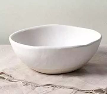 a white bowl sitting on top of a table