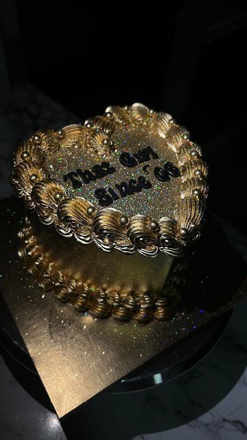 a cake that is sitting on top of a table and has writing on the frosting