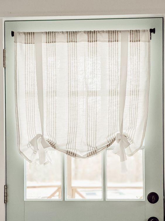 an open door with a white curtain hanging from it's side