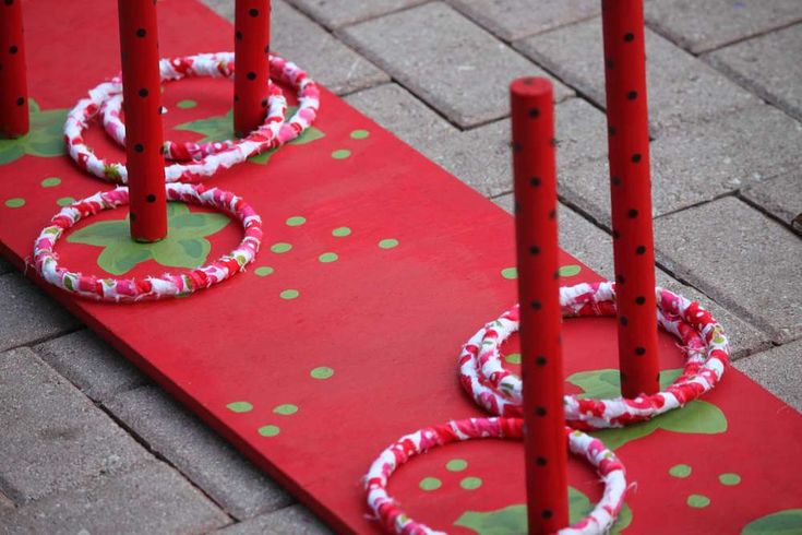 some red poles with white and green circles around them on the ground next to each other