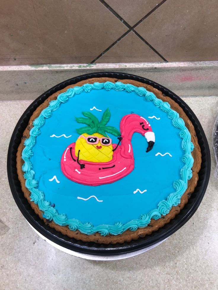 there is a cake with a flamingo on it and a pineapple in the middle