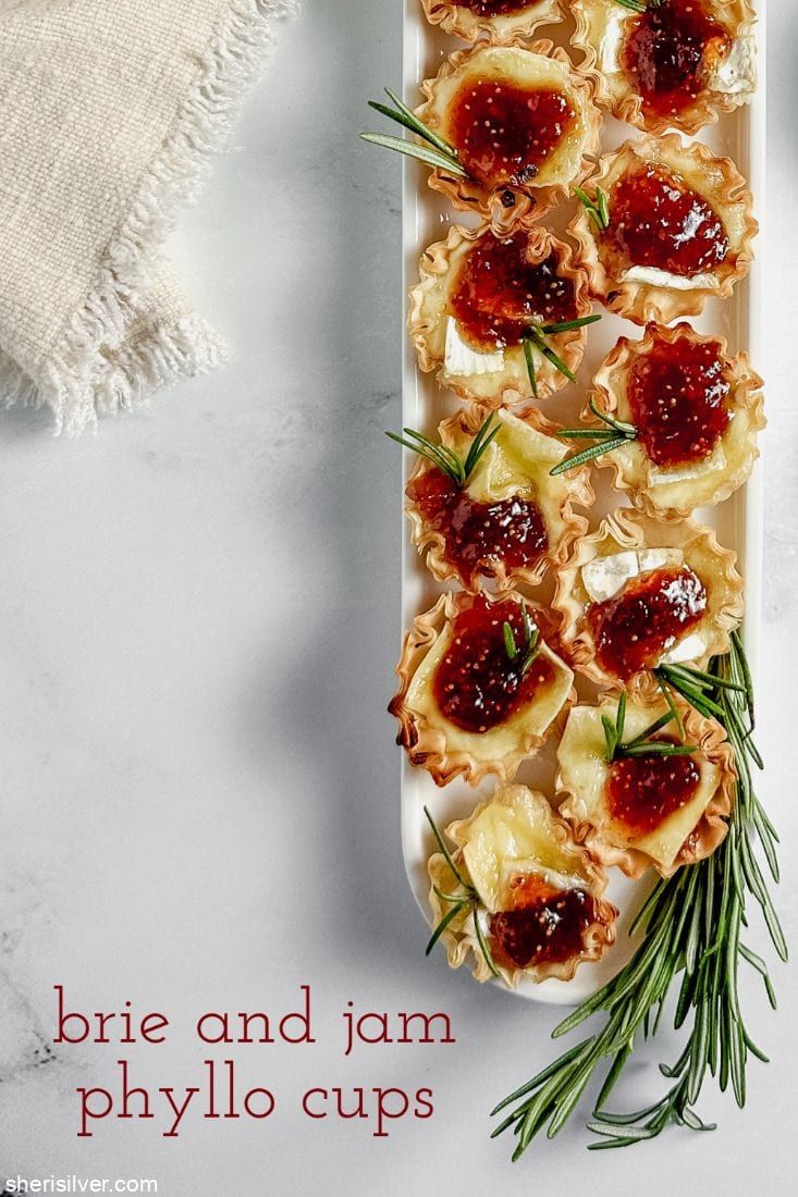 the appetizers are ready to be eaten on the platter with rosemary sprigs