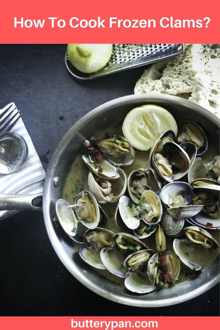 a pan filled with clams on top of a table