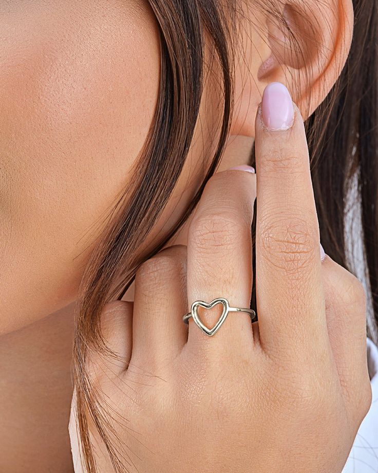 Simple and sweet, this open heart ring is a perfect gift for any special woman in your life! The delicate band has a chic heart-shaped design. Available in gold and silver tones. Materials: 14K gold plated sterling silver or sterling silver Features: 1.5mm band, 0.45" heart, Lead & Nickel free, open band- allows for minor adjustments Elegant Heart-shaped Stackable Rings, Elegant Heart-shaped Midi Rings For Promise, Elegant Heart-shaped Midi Promise Rings, Valentine's Day Minimalist Midi Rings, Dainty Heart-shaped Midi Rings, Heart-shaped Stackable Rings As A Gift, Heart-shaped Dainty Midi Rings For Valentine's Day, Dainty Heart-shaped Midi Rings For Valentine's Day, Minimalist Heart Cut Stackable Rings