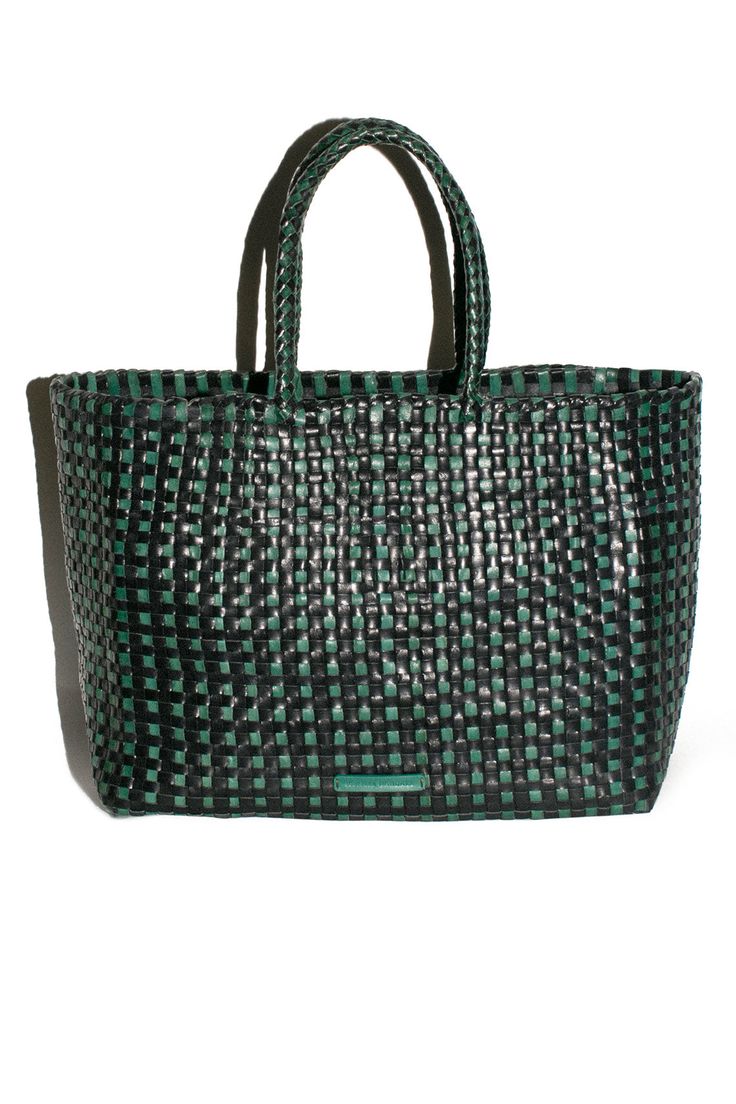 Forest green and black check woven leather tote with tonal woven handles. Tote measures W: 11.75 x D: 5.5" x 9.75" with a 7" Handle Drop. Fabric is 100% Buffalo Leather. *Buffalo leather develops a beautiful patina by deepening in color over time. It is vulnerable to water stains and tonal changes from the sun. It is recommended to avoid contact with lighter fabrics, as vegetable dyes have the potential to transfer. Luxury Woven Green Bag, Luxury Green Woven Bag, Green Top Handle Bag With Intrecciato Weave, Green Woven Leather Shoulder Bag For Everyday Use, Green Tote Bag With Intrecciato Weave, Green Intrecciato Weave Top Handle Bag, Green Woven Leather Shoulder Bag For Errands, Green Intrecciato Weave Tote Bag, Modern Green Bags With Braided Handles