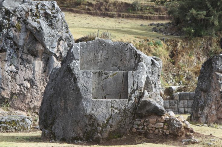 an old stone structure in the middle of some rocks