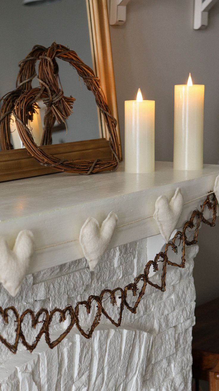 a mantle with candles and some hearts on it