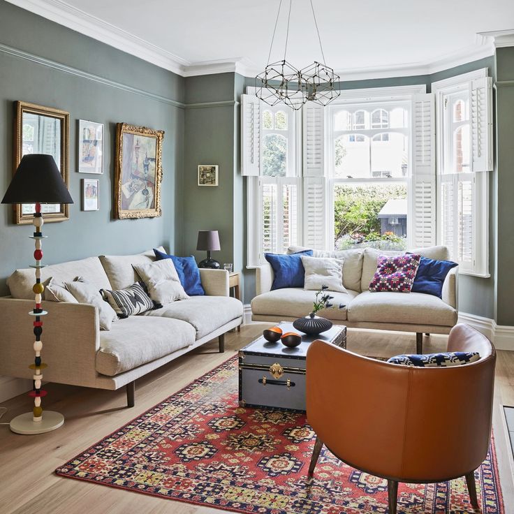 a living room filled with furniture and windows