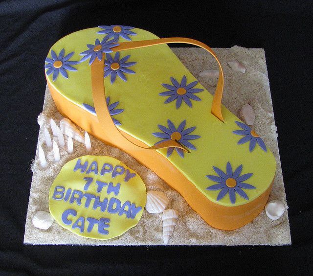 a birthday cake made to look like a pair of flip flops with flowers on them