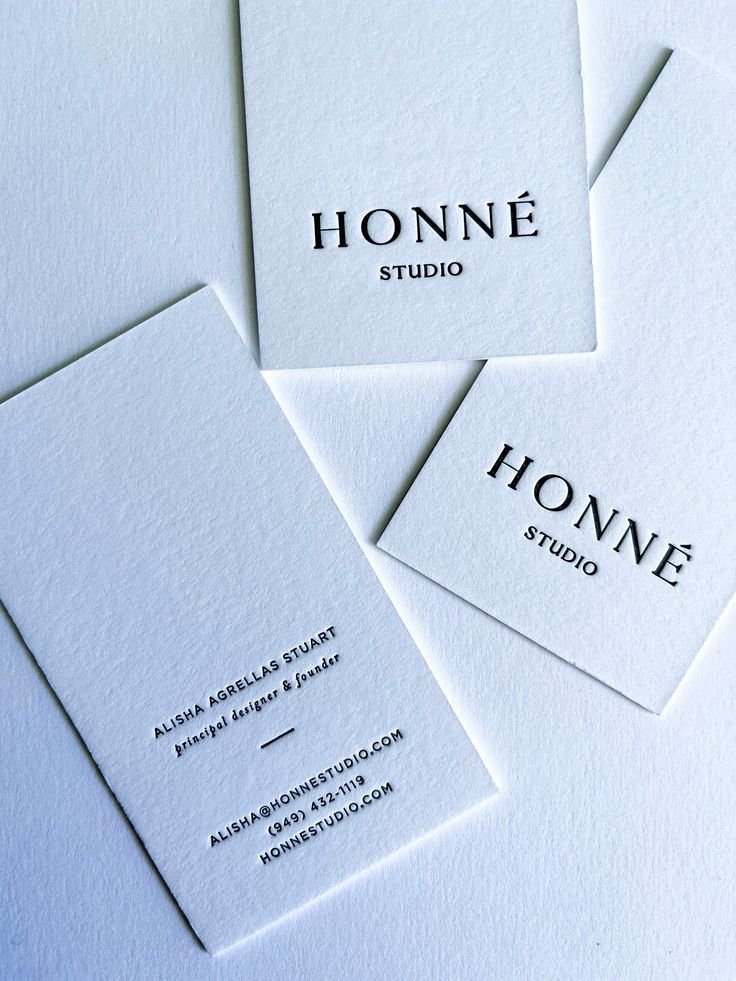 four business cards with the name honne studio written on them, all in black and white