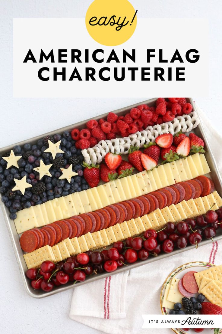 an american flag platter with cheese, fruit and crackers in it on a white table