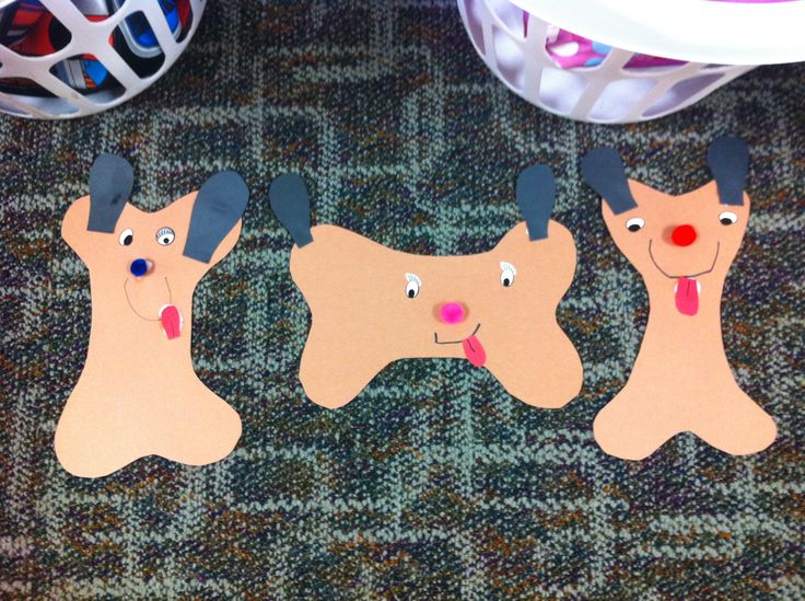 three dogs cut out from cardboard on the floor