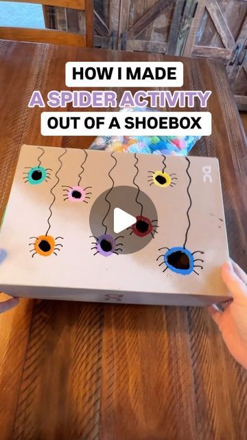 someone is holding up a box with an image on it and the words how i made a spider activity out of a shoebox