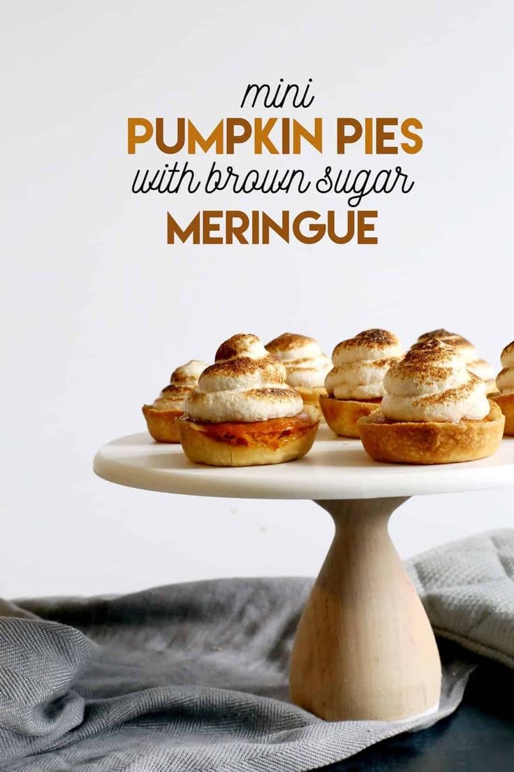 mini pumpkin pies with brown sugar meringue on a white cake platter