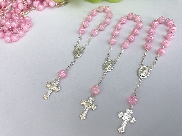 45 beautiful small rosaries for baptism favors they are pearlized pink color beads in the shape of a cute rose bud, accented in gold or silver tone . beads are 6mm imported, acrylic in the shape of a rose bud all hand made with image of our lady of guadalupe in center piece. measure 4.5' inches long. small cross has a cute litle heart in the midle. hablamos espanol, si tiene preguntas con gusto le ayudamos Silver Baptism Jewelry With 8mm Beads, Silver Beaded Rosary For First Communion, Silver Jewelry With 8mm Beads For Baptism, Personalized Silver Rosary For Confirmation, Silver Rosary Bracelet With Round Beads For Baptism, Silver Rosary Bracelet With 8mm Beads As Gift, Silver Rosary Bracelet With Round Beads For First Communion, Personalized Silver Rosary For First Communion, Silver Spiritual Rosary Bracelet For First Communion