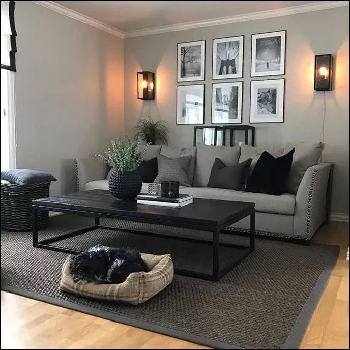 a living room filled with furniture and pictures on the wall above it's coffee table