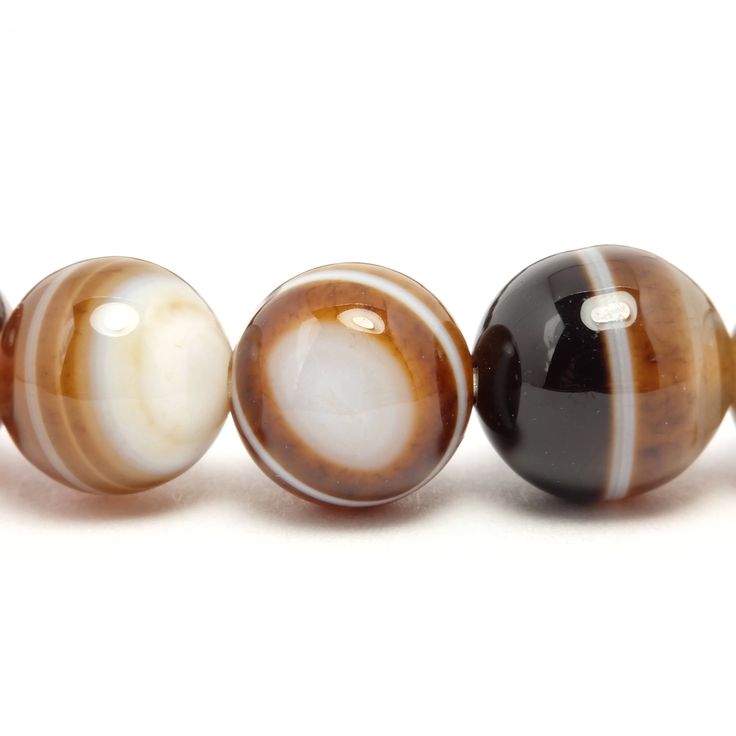 Beads size: 8mm Color: Mixed pattern of dark brown, light brown, and white. Quality: Not clean round shape but glossy look. Each one of pattern is unique. Photo: They are examples of bracelet you'll receive. Same quality, similar color and pattern of beads will be used. 3 PACKAGING STYLE - Bracelet only (light package with no pouch or box) - Jewelry pouch (you can store the bracelet when not in use) - Jewelry pouch & box (Ready for gifting) There'll be no indication of price unless it is shi Brown Polished Beaded Bracelets As Gift, Brown Beaded Bracelets With Natural Stones, Brown Agate Beaded Bracelet With Polished Beads, Brown Gemstone Beaded Bracelets, Spiritual Brown Round Beaded Bracelets, Brown Agate Hand-strung Bracelets, Hand-strung Brown Agate Bracelets, Brown Agate Beaded Bracelets, Brown Agate Beaded Bracelets For Healing