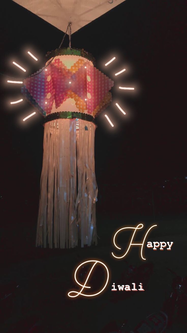 a large paper lantern is lit up at night with the words happy diwali written below it