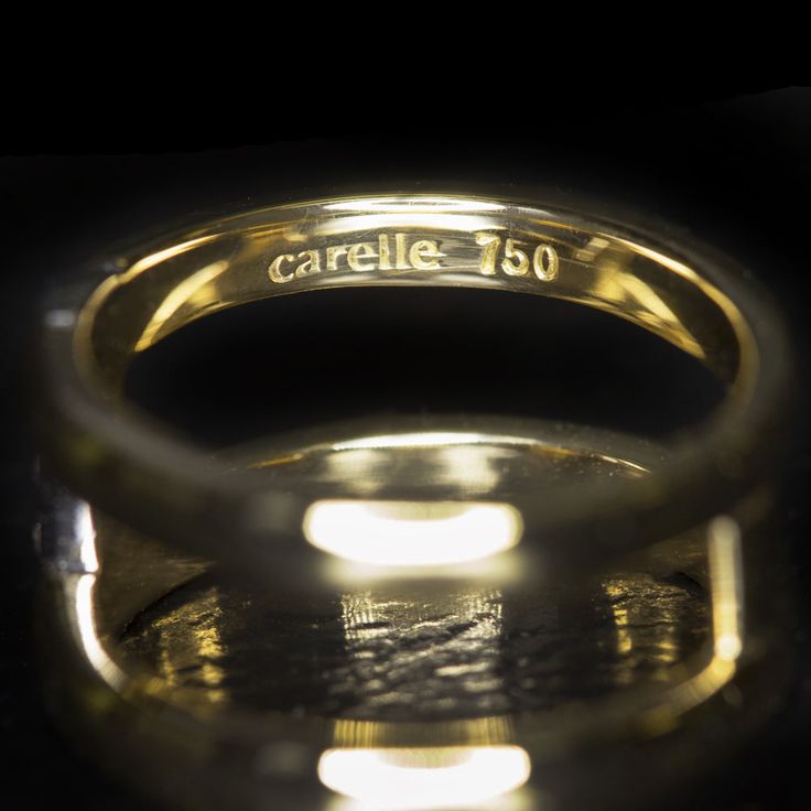 a close up of a ring on a black surface with light coming from it's center