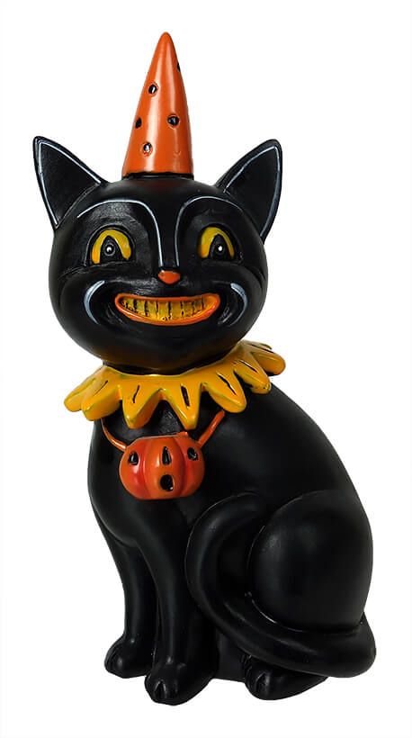 a black cat figurine with an orange pumpkin on its chest