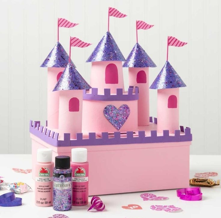 a pink castle with purple turrets and confetti