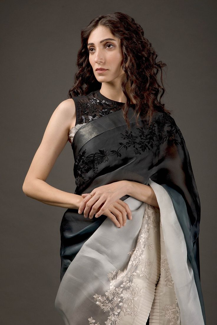 Black and ivory two tone ombre organza saree with resham thread and hand embroidery work. Comes with plain chanderi silk blouse fabric and satin underskirt.
Component: 3
Pattern: Embroidered
Type Of Work: Resham Thread Work
Fabric: Saree: Organza, Blouse Piece: Chanderi Silk
Color: Black, Ivory
Other Details: 
Floral motifs
Pleated hem
Note: The blouse worn by the model is not for sale
Occasion: Reception - Aza Fashions Elegant Organza Blouse Piece For Designer Wear, Evening Saree With Resham Embroidery In Organza, Evening Tissue Silk Saree With Resham Embroidery, Evening Organza Saree With Resham Embroidery, Formal Art Silk Saree With Intricate Embroidery, Elegant Evening Chanderi Saree, Evening Organza Pre-draped Saree With Cutdana, Silk Saree With Cutdana For Evening, Evening Tissue Silk Saree With Cutdana