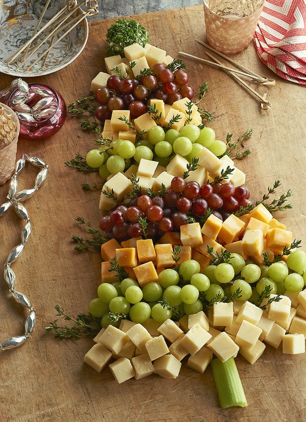 a christmas tree made out of cheese and grapes