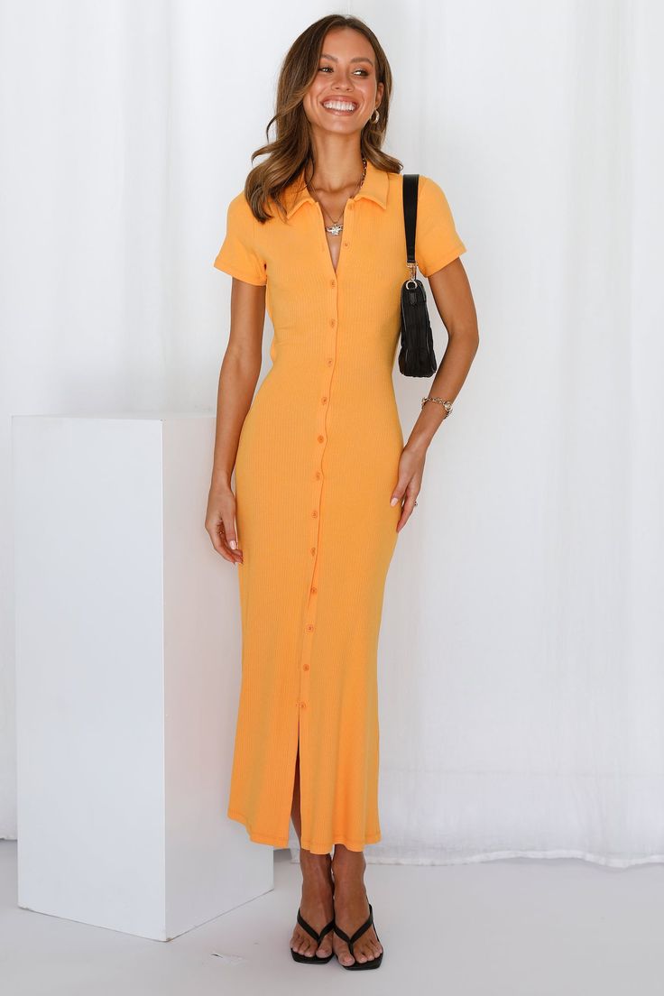 Length from shoulder to hem of size S: 120cm. Orange maxi dress. Non-lined. Cold hand wash only. Model is a standard XS and is wearing size XS. True to size. Ribbed fabric. No zipper. Slip-on style. Rayon/Spandex. You'll hypnotise everyone, without a flute, with the Tied Piper Maxi Dress. The dress has collars and buttons all the way down at the front, backless with an adorable tie. A simple piece that has a bit more personality. Style yours with black mules and a shoulder bag. Orange Maxi Dress, Black Mules, Orange Tie, Dress Orange, Button Dress, Ribbed Fabric, Designer Dresses, Cold Shoulder Dress, The Dress