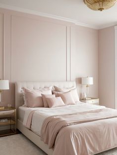 a large bed sitting next to a window in a room with pink walls and furniture