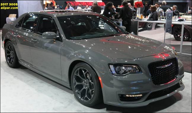 a gray car is on display at an auto show