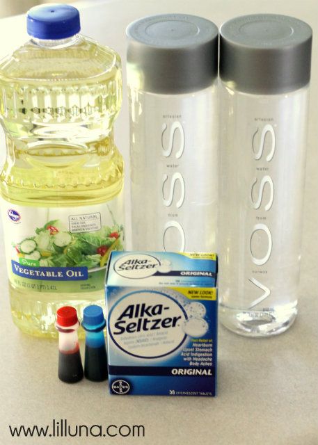 two water bottles, one containing alka - sizer and the other containing disinfectant