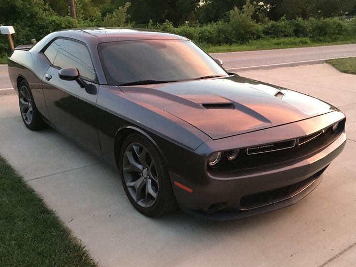 a dark colored sports car parked in the driveway