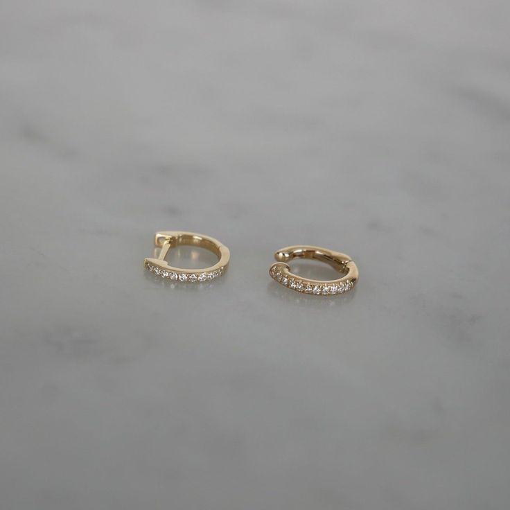 Proof that opposites really do attract. With one pair of huggies and one no-piercing ear cuff, this duo does it all.The Diamond Duo Gift Set includes: A pair of the Diamond Mini Huggie Earrings: With a single row of sparkling pavé diamonds, our signature mini huggie earring brings bold flair to any ear stack. A single Diamond Cartilage Ear Cuff: No piercing required, pavé diamonds, and a comfortable fit. What more could you want? $770 value which means you save 15% and a whole bunch of time sinc Fine Jewelry Diamond Huggie Earrings, Fine Jewelry Huggie Earrings, 14k Gold Huggie Ear Cuff As Gift, White Gold Matching Huggie Earrings, 14k White Gold Huggie Cartilage Earrings, 14k White Gold Huggie Hoop Earrings, Classic Huggie Cartilage Earrings For Anniversary, Timeless Huggie Earrings For Anniversary, Elegant Huggie Style Piercings As A Gift