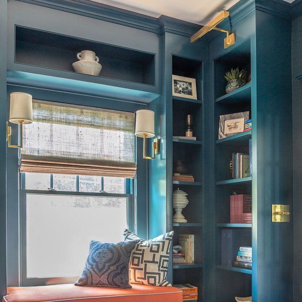 a room with blue walls and built in bookshelves