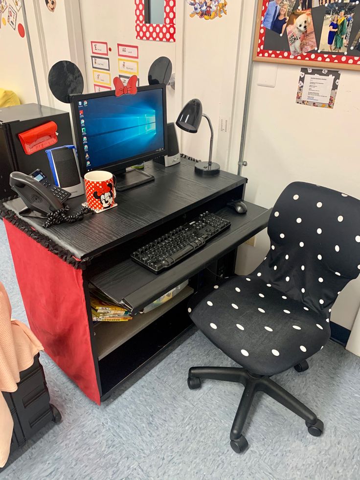 a desk with a chair and computer on it