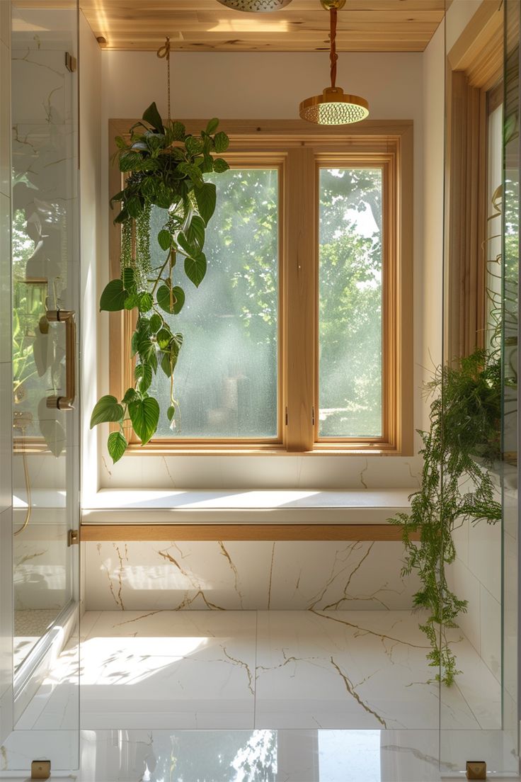 a bathroom with a large window and a plant in the corner