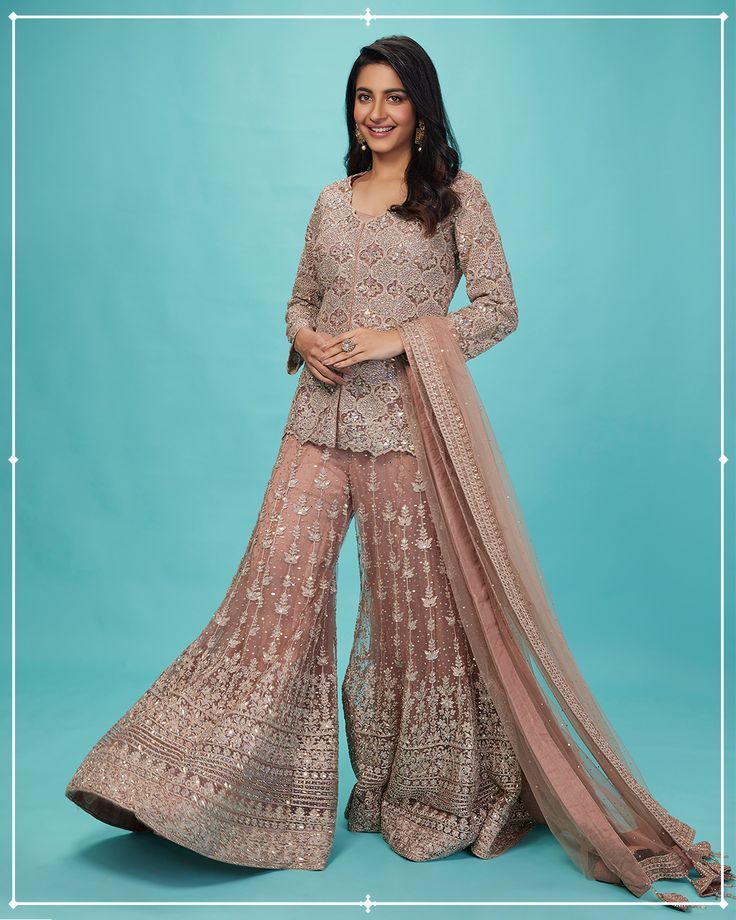 Nothing like an onion pink suit set. With an embroidered short kurti atop a gorgeous sharara, no one will miss a chance to look twice. Mehndi Dress For Bride, Gharara Designs, Onion Pink, Fashion Show Dresses, Desi Wedding Dresses, Lehenga Designs Simple, Short Kurti, Pakistani Fancy Dresses, Sharara Suit