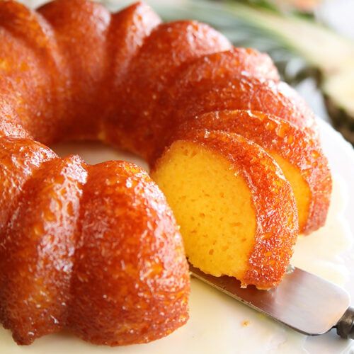 a bundt cake sitting on top of a white plate with a knife in it