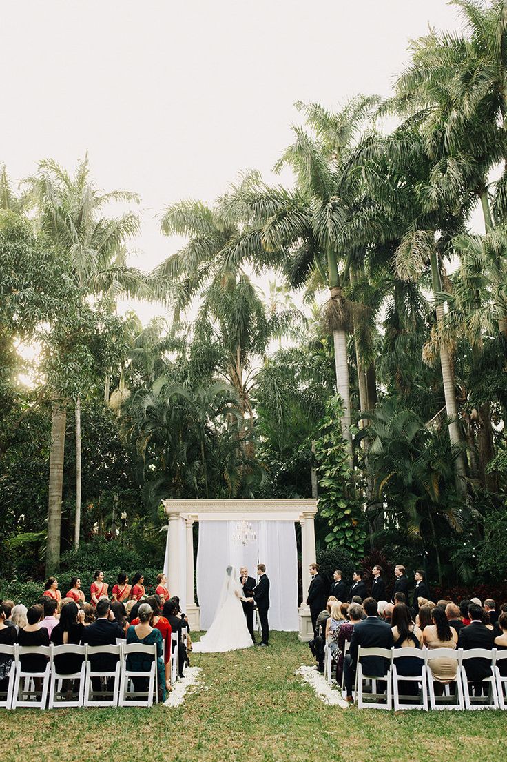 a wedding ceremony in the middle of palm trees